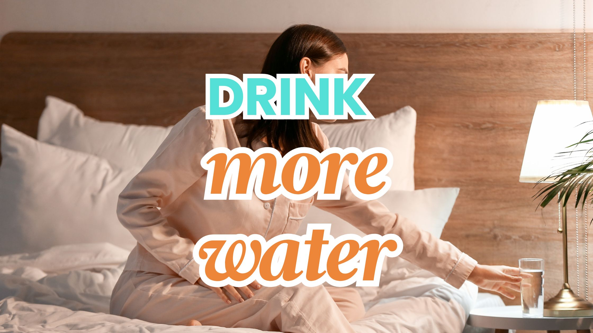 woman on bed taking a sip of water